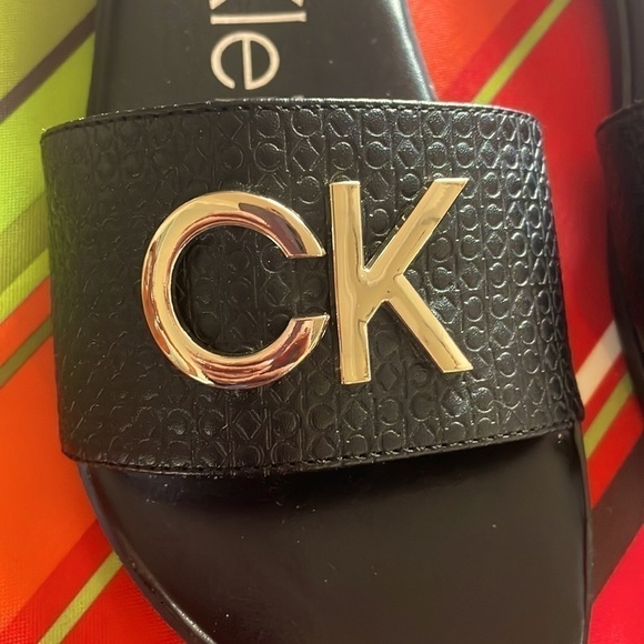 Brand New Calvin Klein Black Large Strap Sandals Flats w/ Gold Tone Metal Logo - Picture 5 of 12